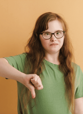 girl-wearing-green-shirt-thumbs-down-unhappy