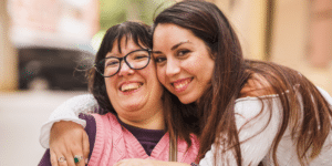 two women smiling, one of them is ndis participant plan hero plan managers