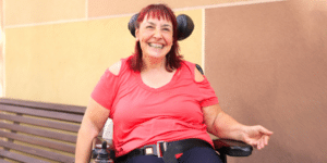 women smiling sititng on a wheelchair ndis participants plan hero