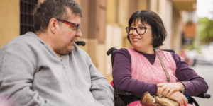 two people smiling sitting on wheelchair