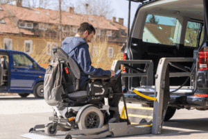 a disabled person on wheelchair getting on a car