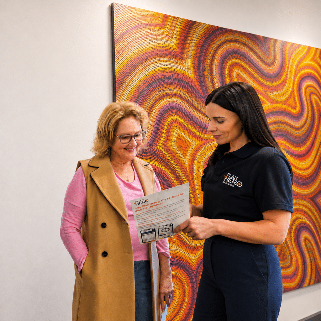 ndis plan manager amanda showing an ndis participant a brochure of plan hero plan management at nsw office